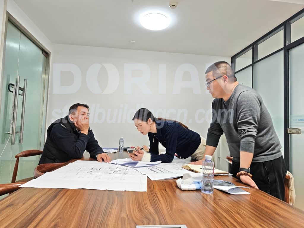 Steel building design consultation with professionals in a modern office setting.