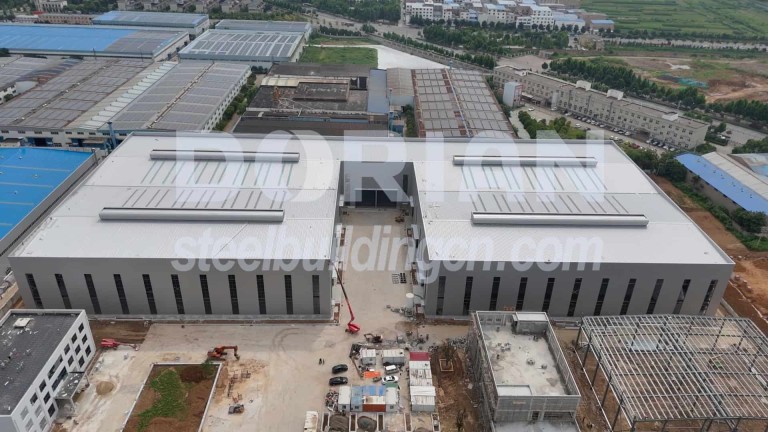 Construction site of a 9652 sqm steel warehouse in Guatemala with solar panels on the roof. Large Steel Structure Warehouse in Guatemala