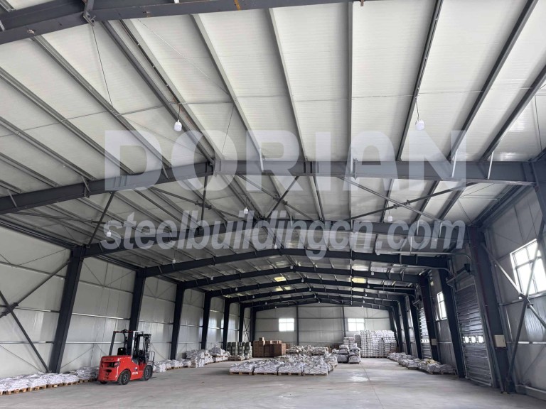 Interior view of a large steel structure warehouse with organized storage and high ceilings. Steel Structure Warehouse Interior